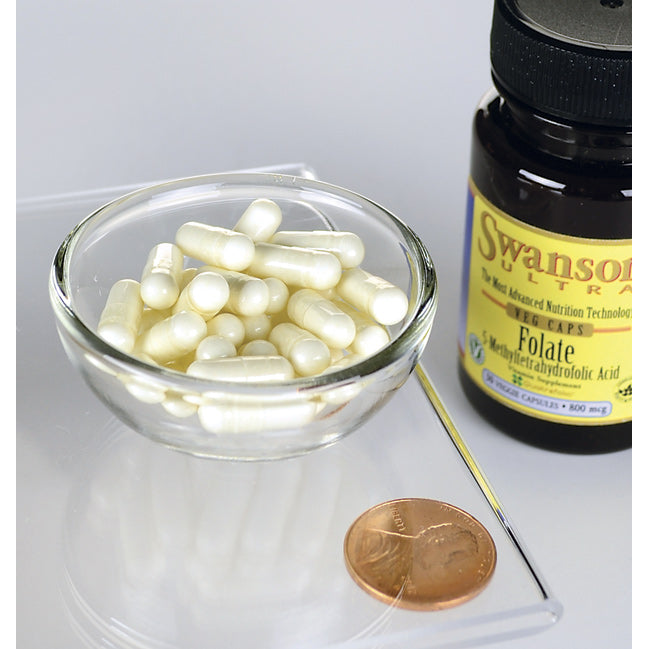 A bottle of Swanson Folate 5-MTHF - 800 mcg 30 capsules and a penny next to it.
